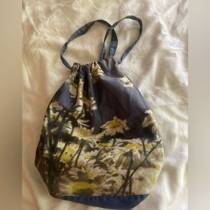 Vintage, small cotton backpack. Daisy print on blue background.